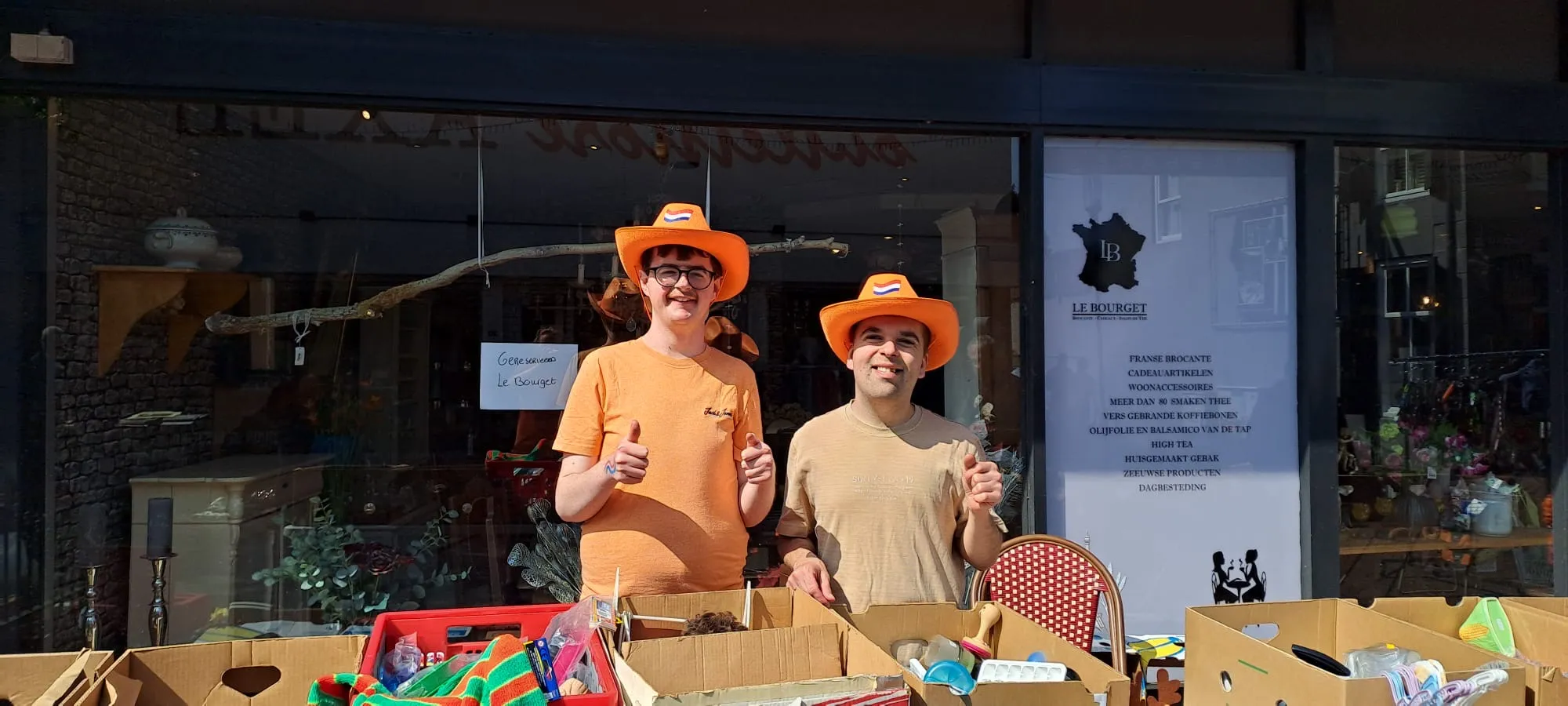 Deelnemers achter de kramen van de rommelmarkt op Koningsdag